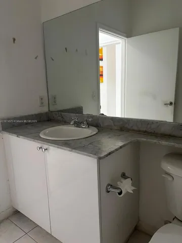 a bathroom with a toilet and a shower curtain