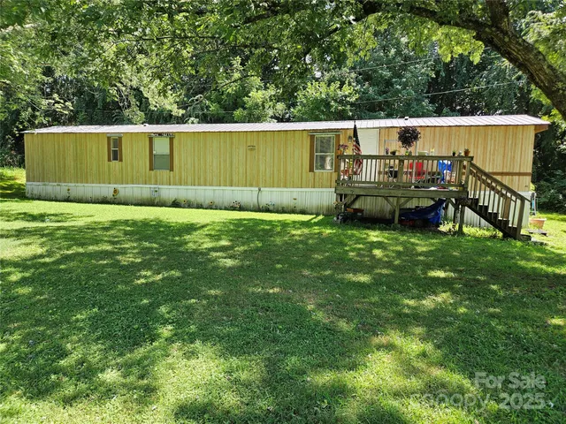 a view of an house with backyard space and sitting area