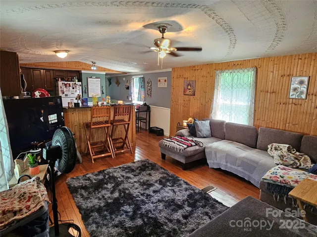 a living room with furniture a dining table and a fireplace