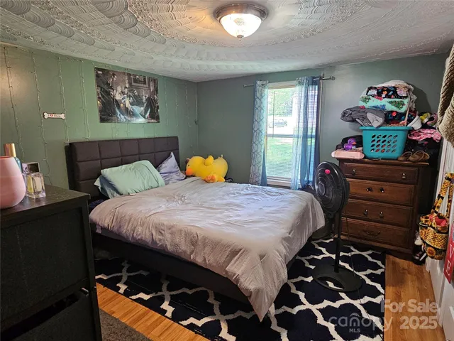 a bedroom with a bed and a dresser