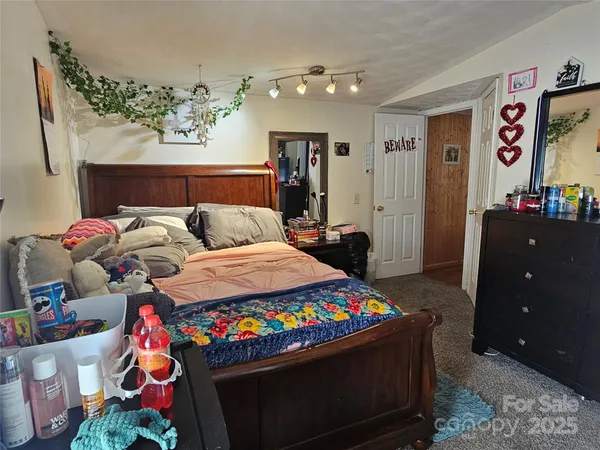 a bed sitting in a bedroom next to a window