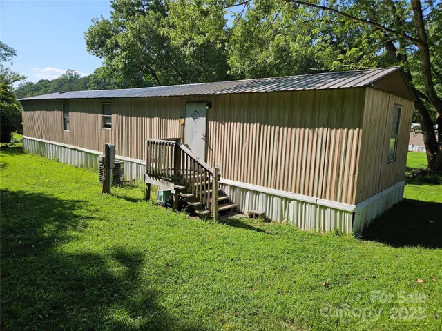 a backyard of a house with wooden floor and fence