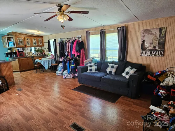 a living room with furniture gym equipment and a flat screen tv