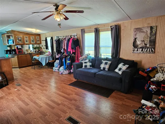 a living room with furniture gym equipment and a flat screen tv