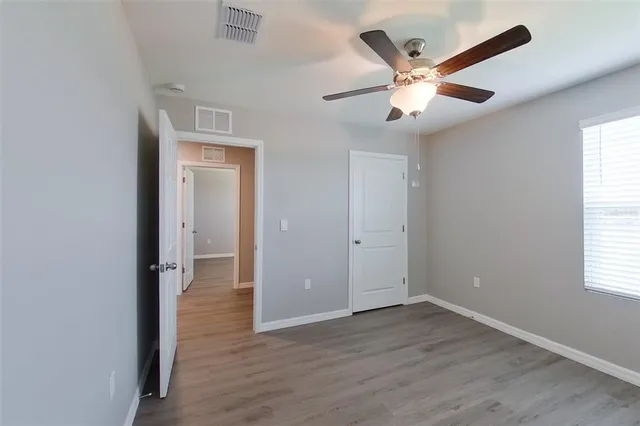 wooden floor in an empty room with a window