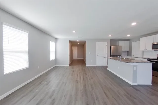 a view of kitchen with sink and wooden floor