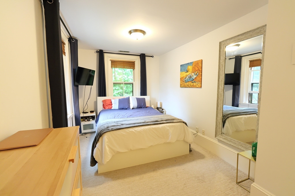 107 Waban Hill Road, Unit R Newton, MA 02467 - Photo 15 of 21 a bed room with a bed and a chair