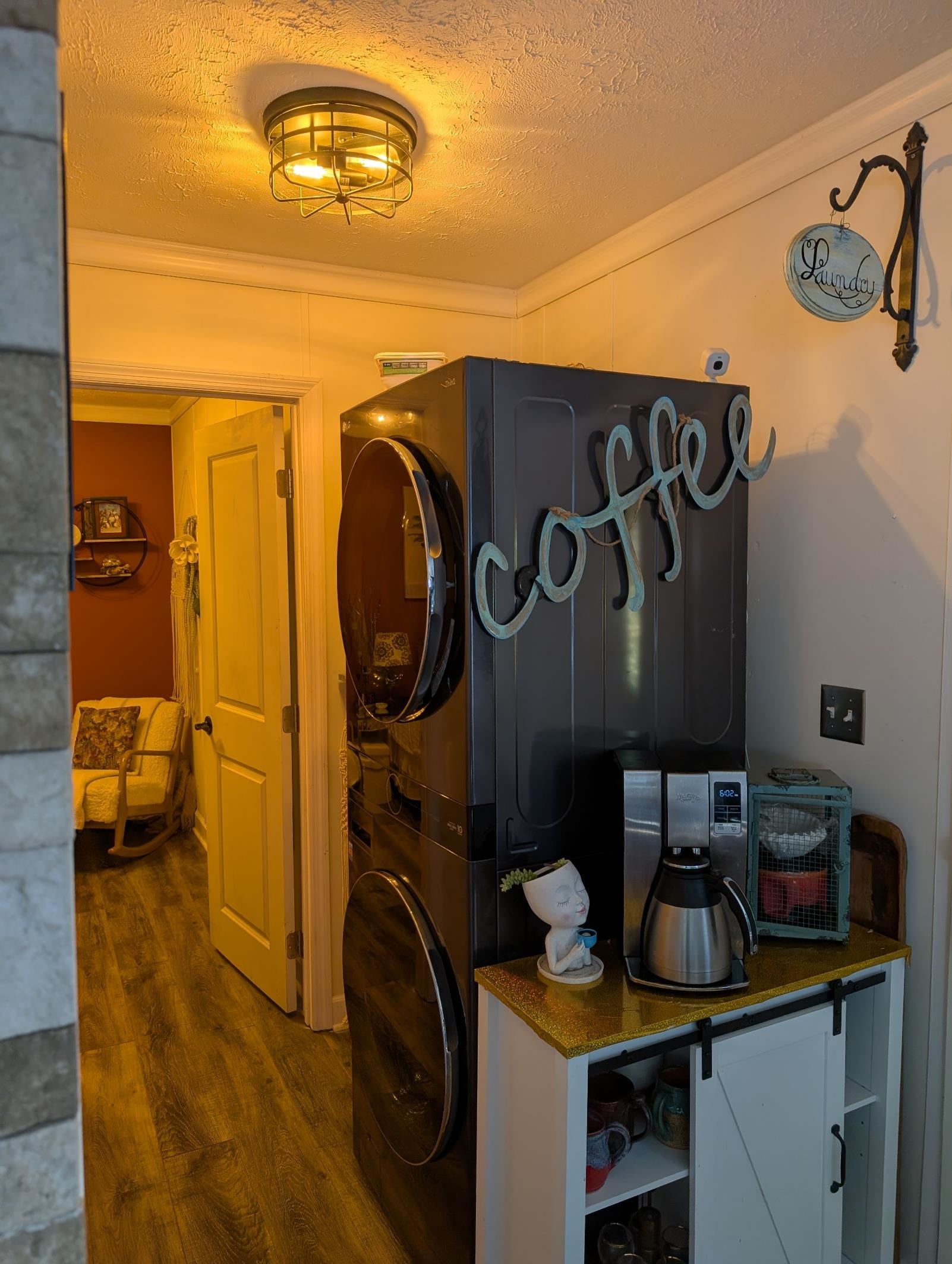 3 Poolside Drive Murrells Inlet, SC 29576 - Photo 15 of 40 Laundry area featuring dark wood finished floors, a textured ceiling, stacked washer / drying machine, and ornamental molding
