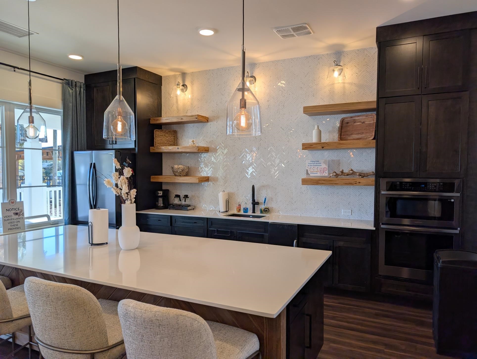 3 Poolside Drive Murrells Inlet, SC 29576 - Photo 28 of 40 Kitchen with open shelves, a kitchen breakfast bar, decorative light fixtures, and stainless steel double oven
