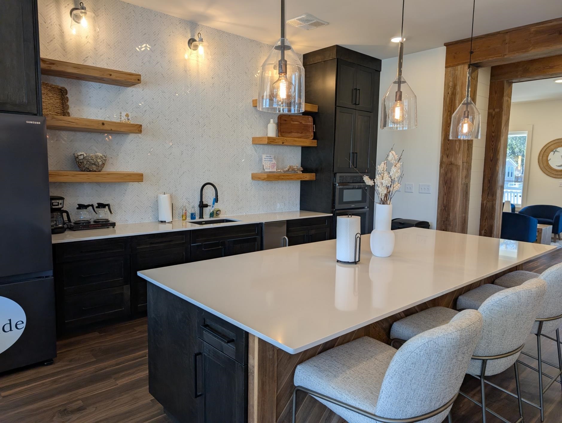 3 Poolside Drive Murrells Inlet, SC 29576 - Photo 29 of 40 Kitchen featuring dark cabinets, open shelves, a kitchen bar, and black appliances