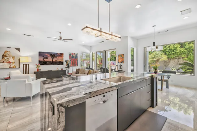 a kitchen with stainless steel appliances granite countertop a sink and a stove