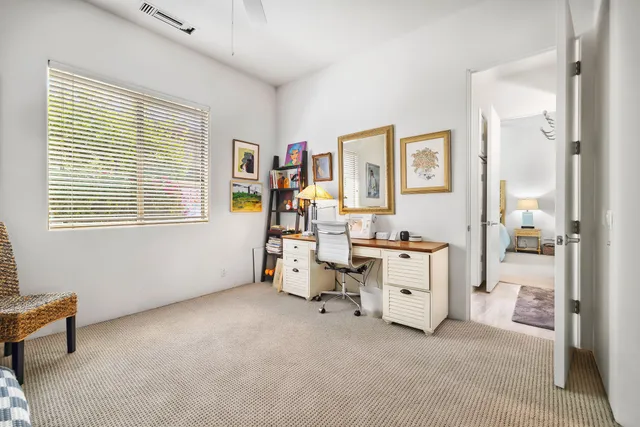 a view of livingroom with workspace and a window
