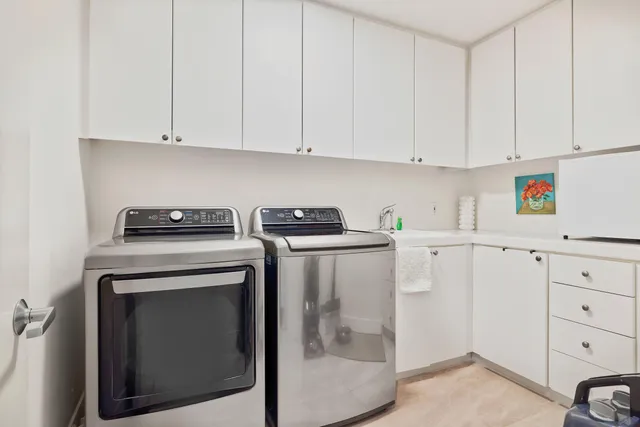 a view of a storage and utility room with washer and dryer