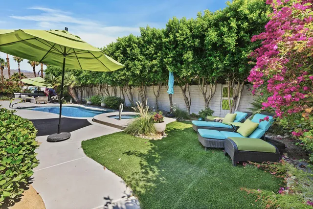 a view of a backyard with sitting area and furniture