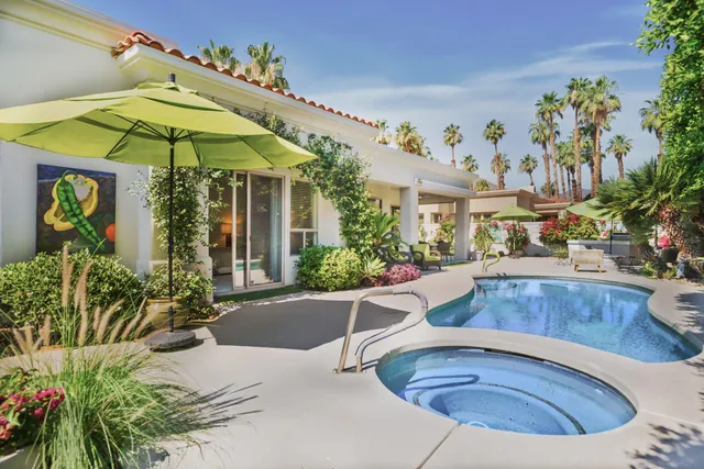 a view of a house with swimming pool and sitting area