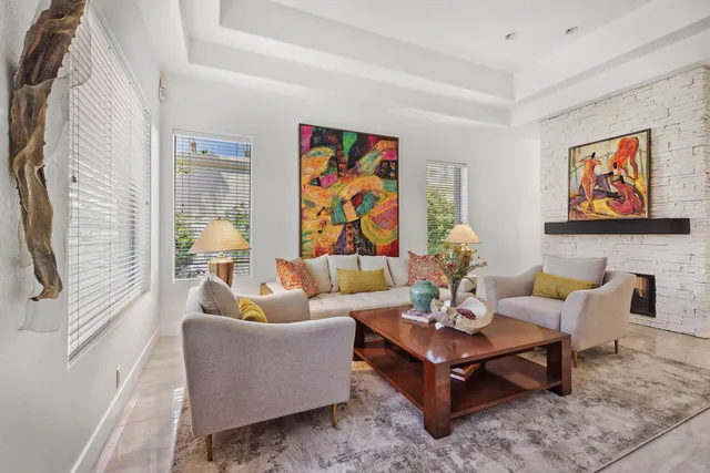 a living room with furniture and wall paintings