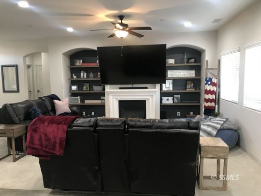 124 Rancho Del Cerro Ridgecrest, CA 93555 - Photo 4 of 21 a living room with furniture a flat screen tv and a fireplace