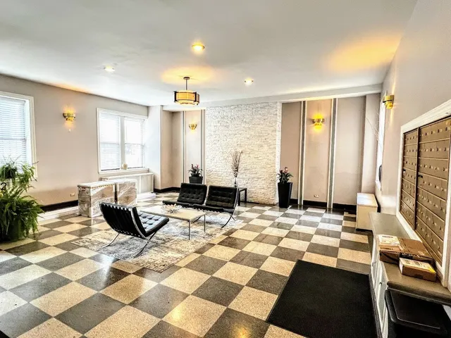 a living room with a gaming machine and a rug