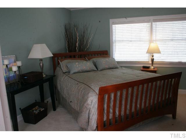 801 Brookfield Road Raleigh, NC 27615 - Photo 9 of 17 a bedroom with a bed and a lamp