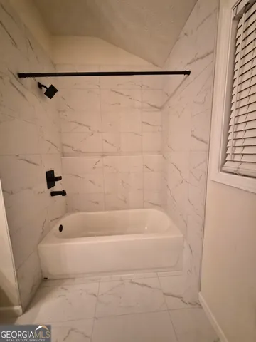 a bathroom with a shower and a bathtub