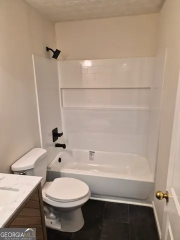 a bathroom with a sink a toilet and a bathtub