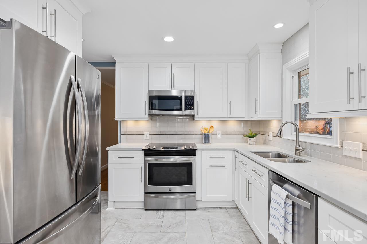 456 Peppermill Road Sanford, NC 27332 - Photo 5 of 39 a kitchen with stainless steel appliances granite countertop a refrigerator sink and stove