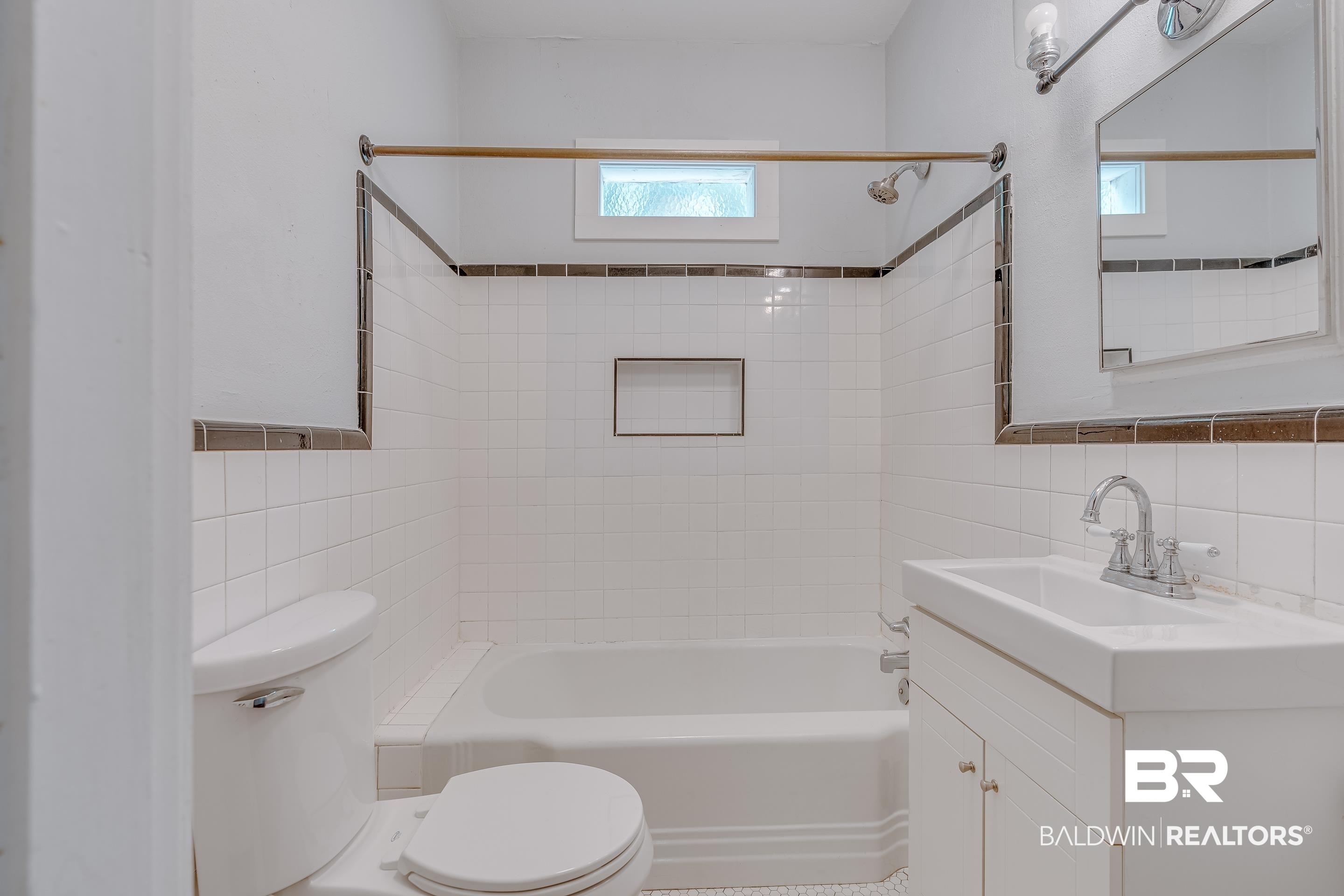 1852 Old Shell Road Mobile, AL 36607 - Photo 14 of 26 Bathroom with tile walls, washtub / shower combination, and vanity