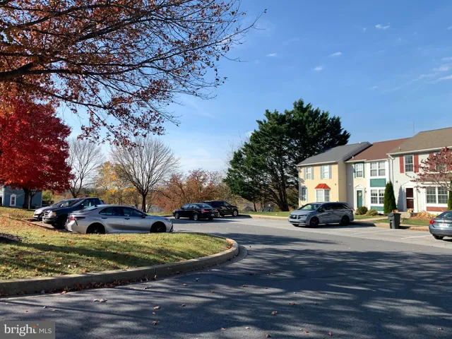 a view of road with card parked on side and road