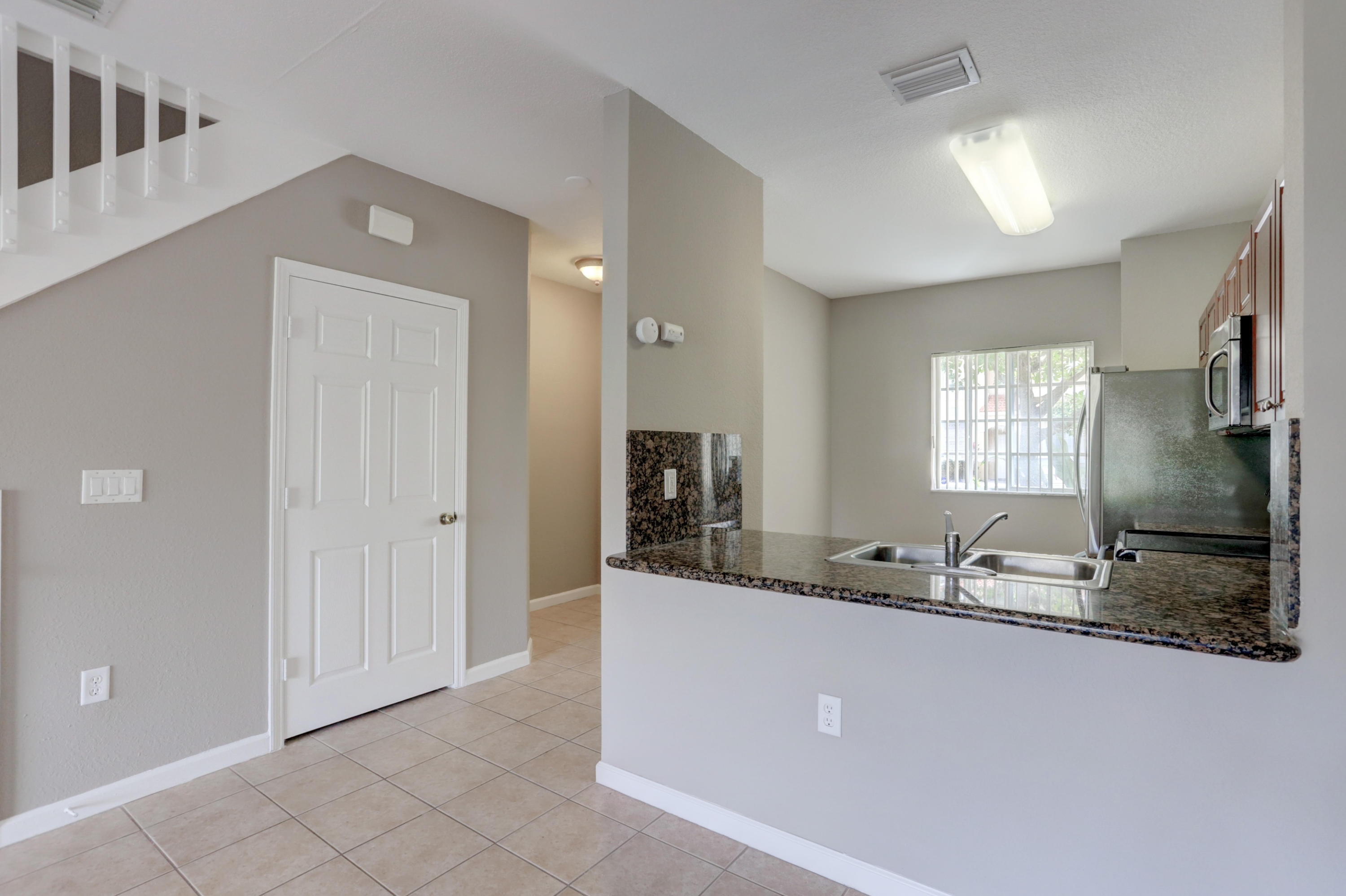 5909 Riverside Avenue Tamarac, FL 33321 - Photo 12 of 32 a bathroom with a granite countertop double vanity sink and mirror