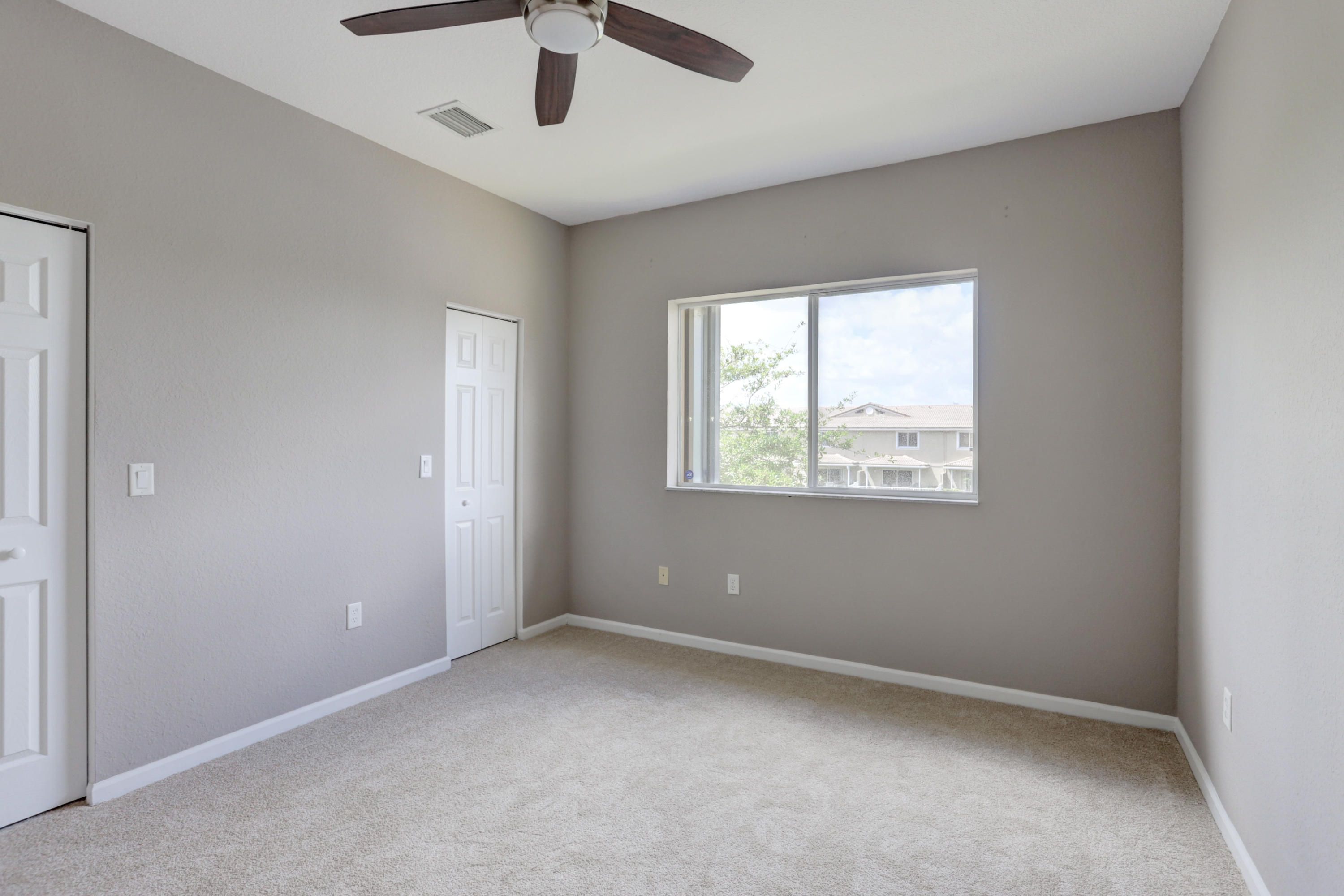 5909 Riverside Avenue Tamarac, FL 33321 - Photo 6 of 32 an empty room with a window and a ceiling fan