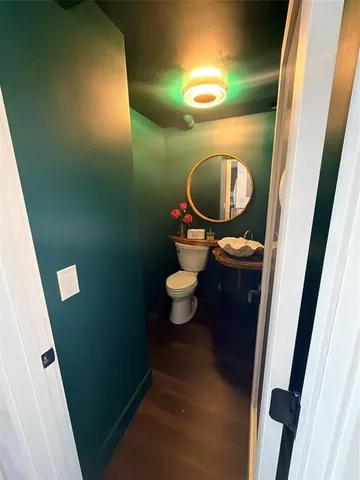 a bathroom with a toilet and a mirror