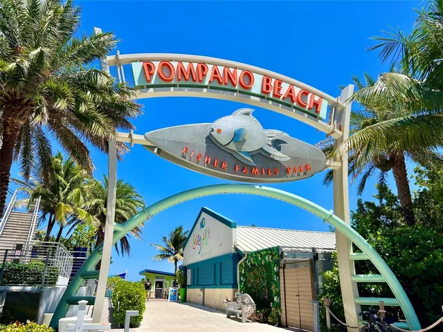 a blue swimming pool with outdoor seating and yard