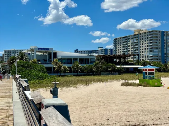 a swimming pool view with a seating space and a garden
