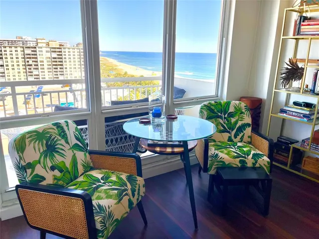 a living room filled with furniture and a potted plant