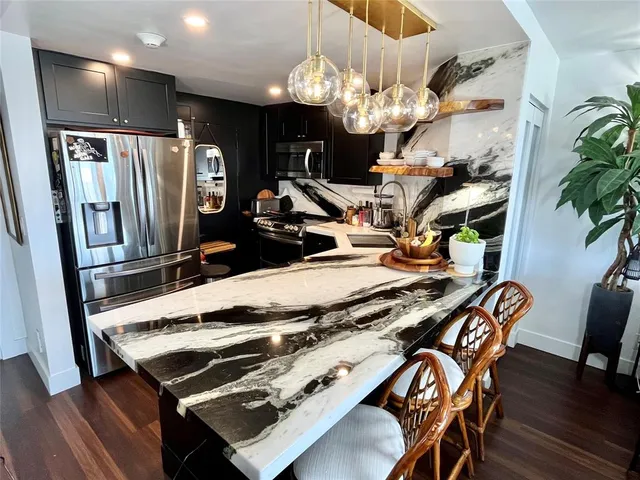 a view of a dining room with furniture and chandelier