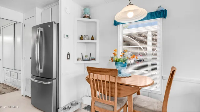 a dining room with furniture wooden floor and a window