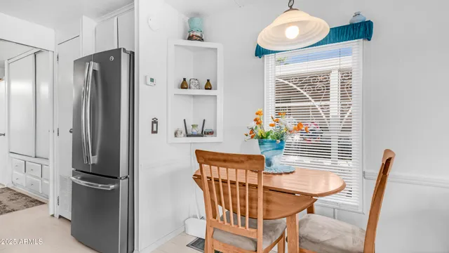 a view of a refrigerator and wooden floor