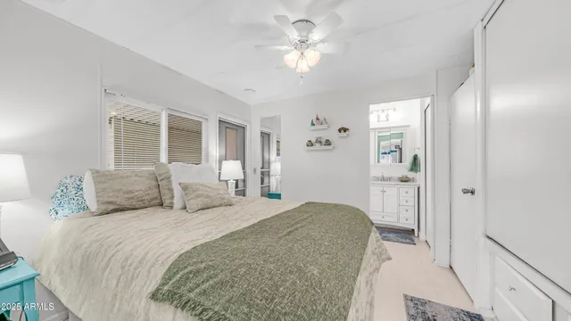 a bedroom with a bed and a lamp on table