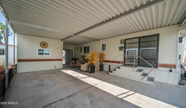 a large living room with stainless steel appliances kitchen island granite countertop furniture and a fireplace