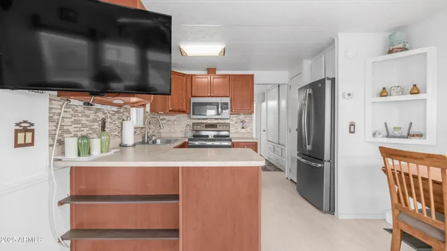 a kitchen with stainless steel appliances granite countertop a sink stove and microwave