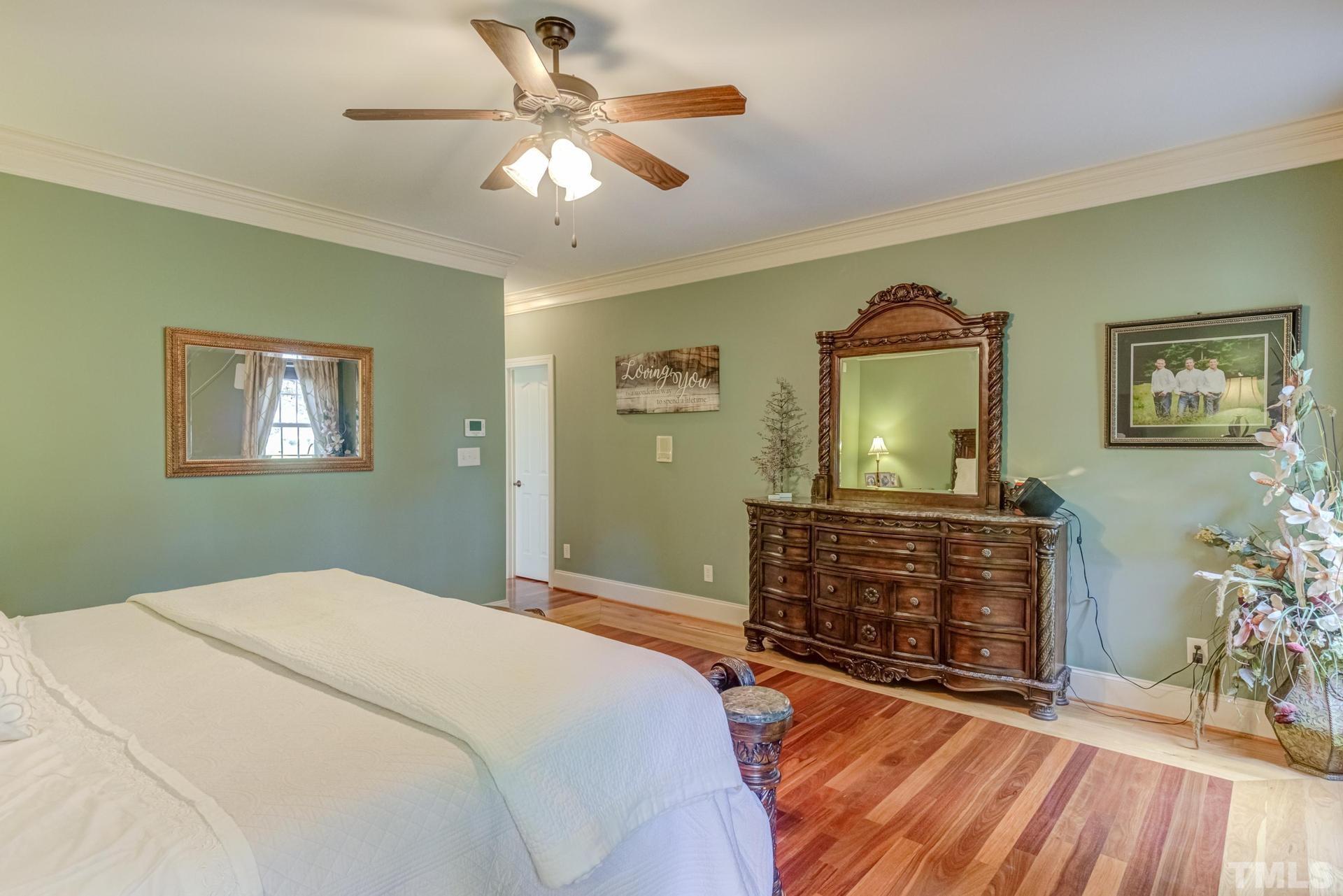 108 Challenge Road Raleigh, NC 27603 - Photo 23 of 60 a bedroom with a bed and a chandelier