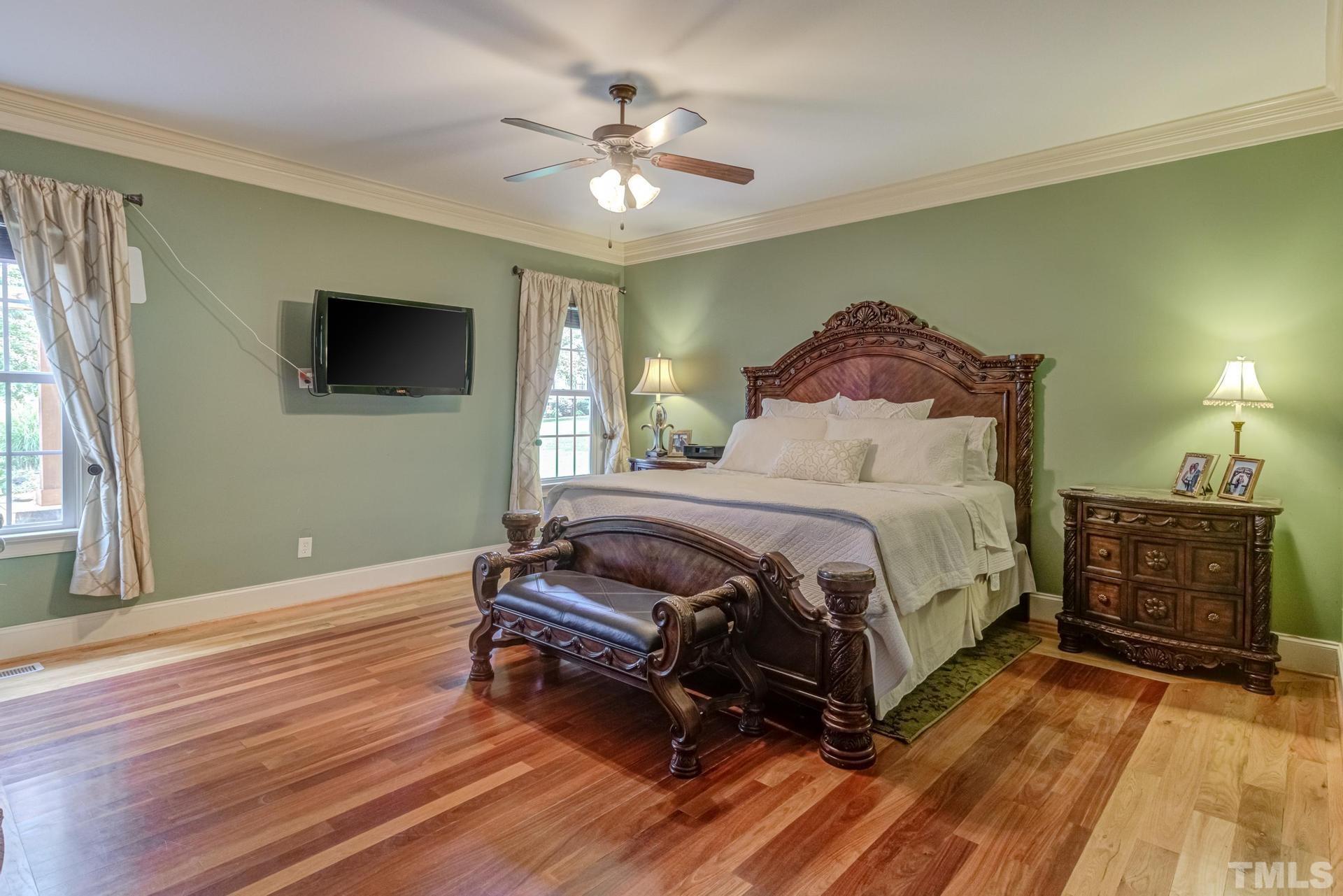 108 Challenge Road Raleigh, NC 27603 - Photo 25 of 60 a bedroom with a bed and a chandelier