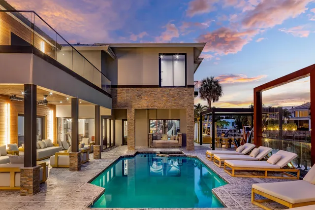 a view of a patio with a table chairs and a backyard