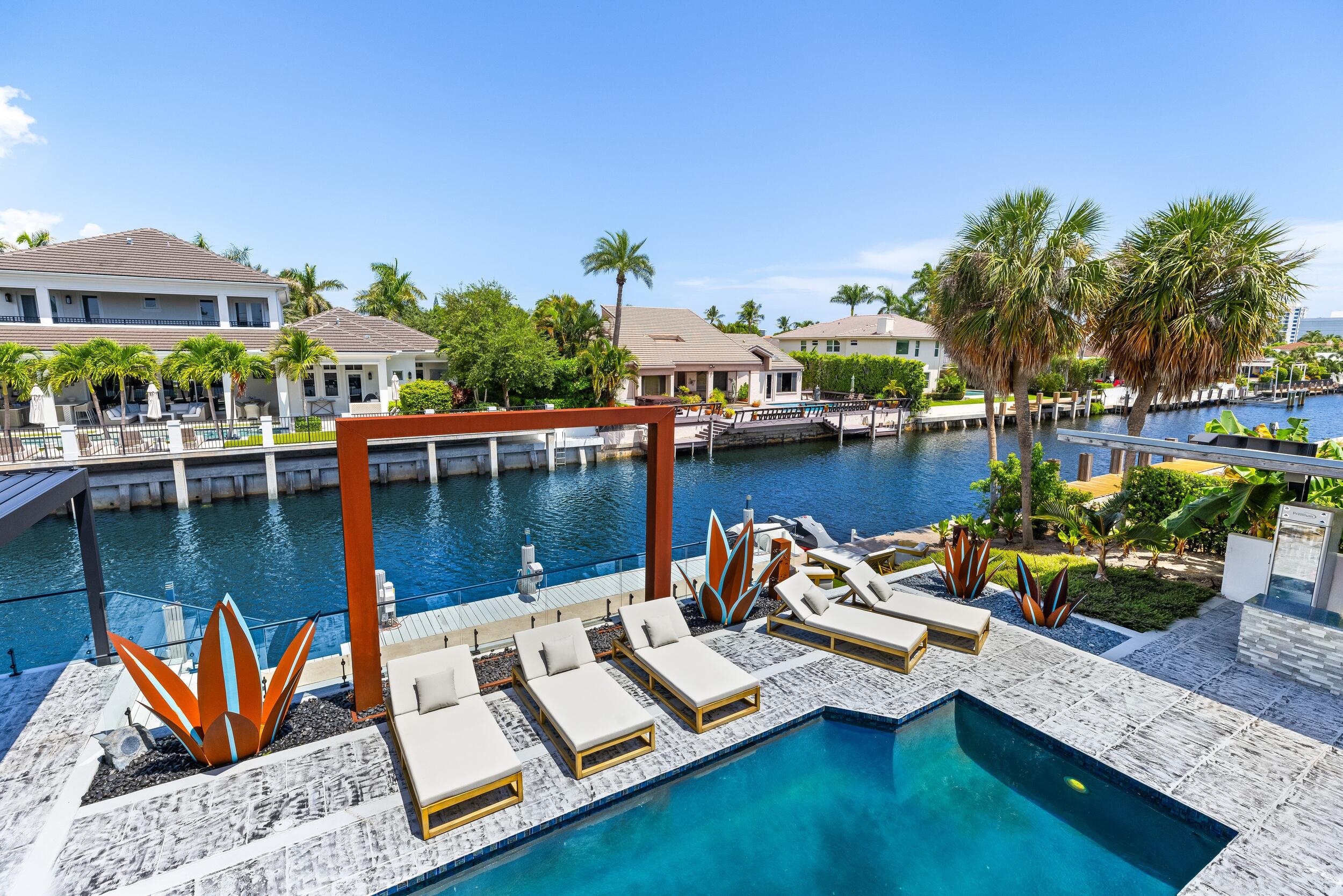 839 Northeast Bay Isle Drive Boca Raton, FL 33487 - Photo 14 of 103 a view of a lake with lawn chairs