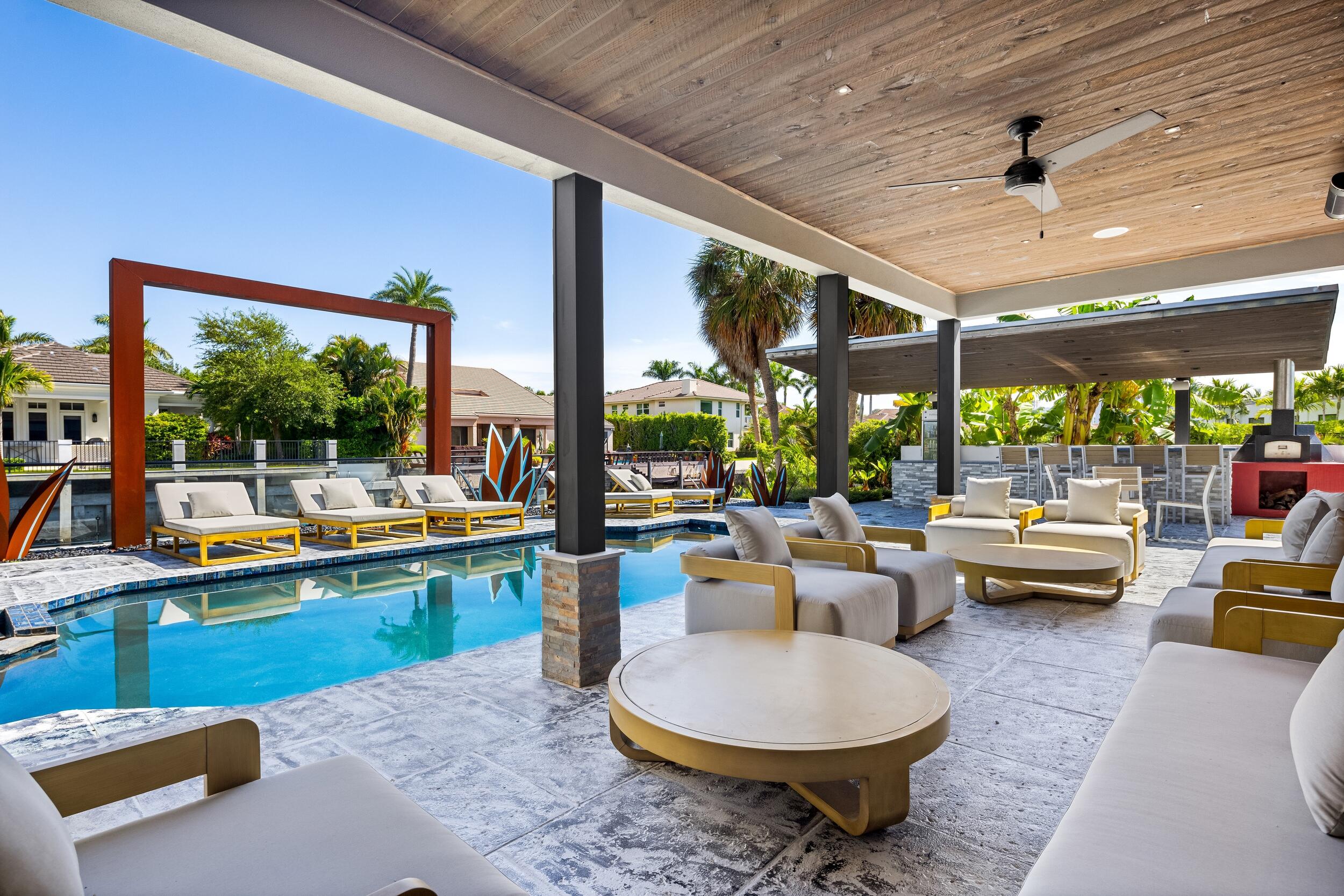 839 Northeast Bay Isle Drive Boca Raton, FL 33487 - Photo 16 of 103 a living room with patio furniture and a floor to ceiling window