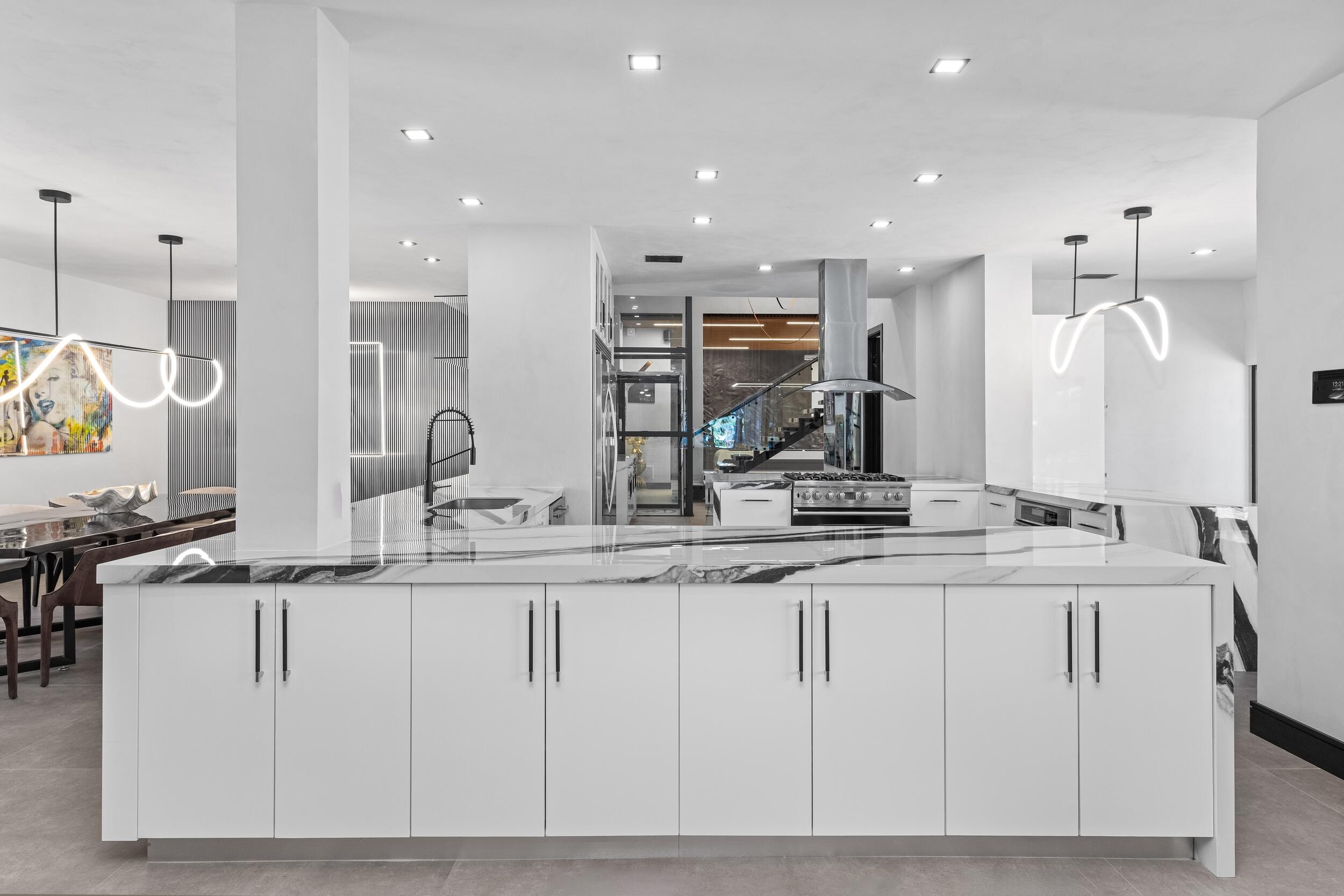 839 Northeast Bay Isle Drive Boca Raton, FL 33487 - Photo 24 of 103 a kitchen with stainless steel appliances granite countertop a sink and a refrigerator