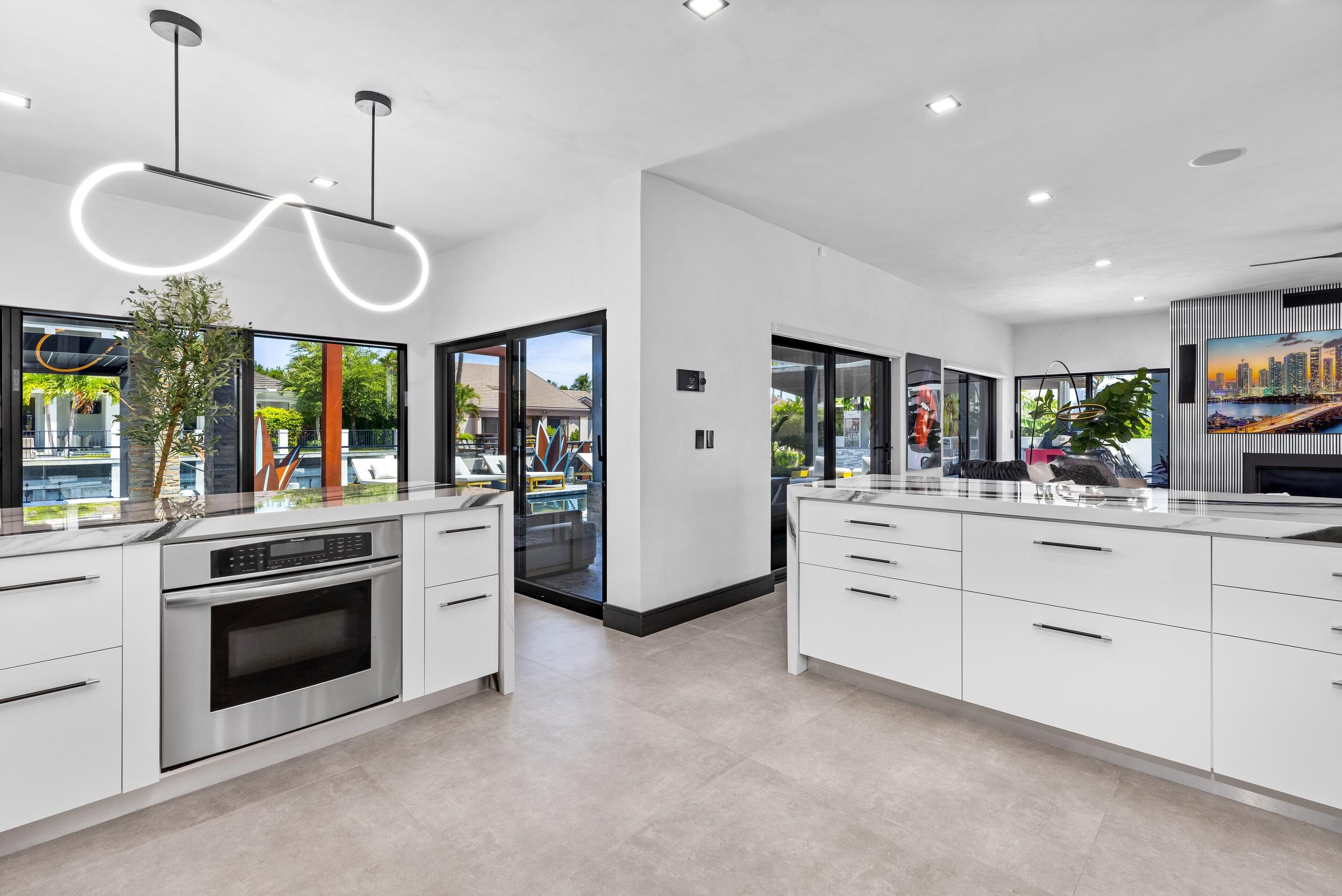 839 Northeast Bay Isle Drive Boca Raton, FL 33487 - Photo 25 of 103 a kitchen with stainless steel appliances granite countertop a stove and a sink
