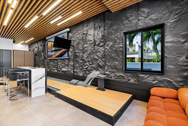 a bedroom with a bed couch and painting on the wall