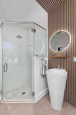 a view of a swimming pool with couches chairs and a potted plant