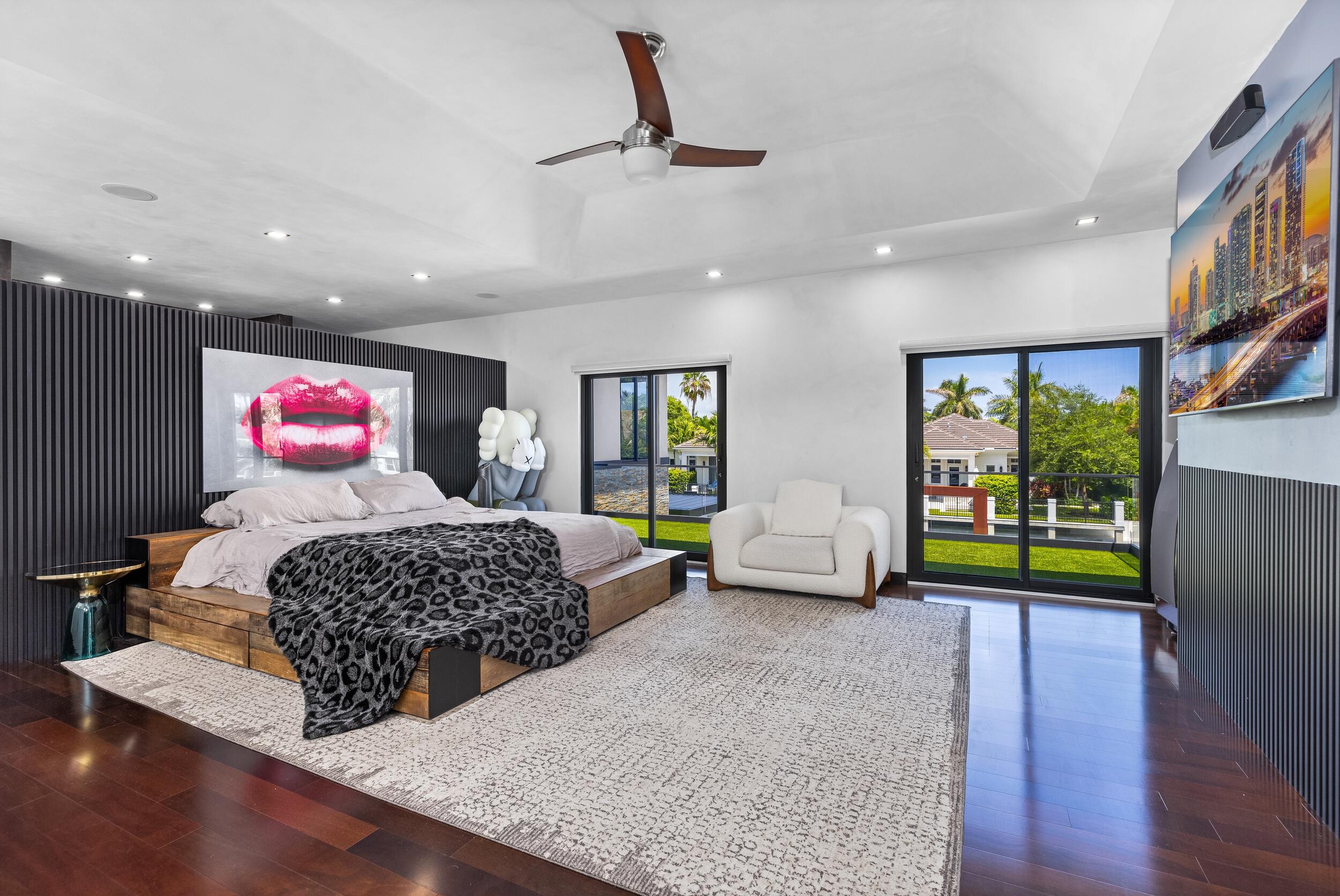 839 Northeast Bay Isle Drive Boca Raton, FL 33487 - Photo 52 of 103 a bedroom with furniture and a wooden floor